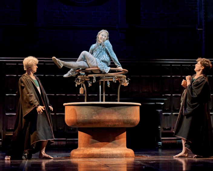Cast on stage. Moaning Myrtle sits on top of a round sink. Scorpius and Albus stand either side looking surprised..